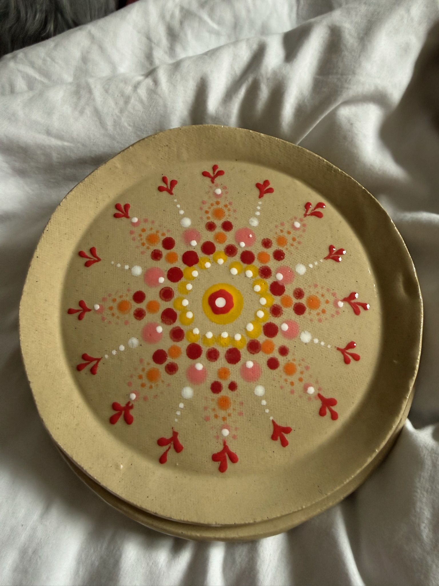 Hand-painted ceramic plate with mandala — first stage, ready for bisque
