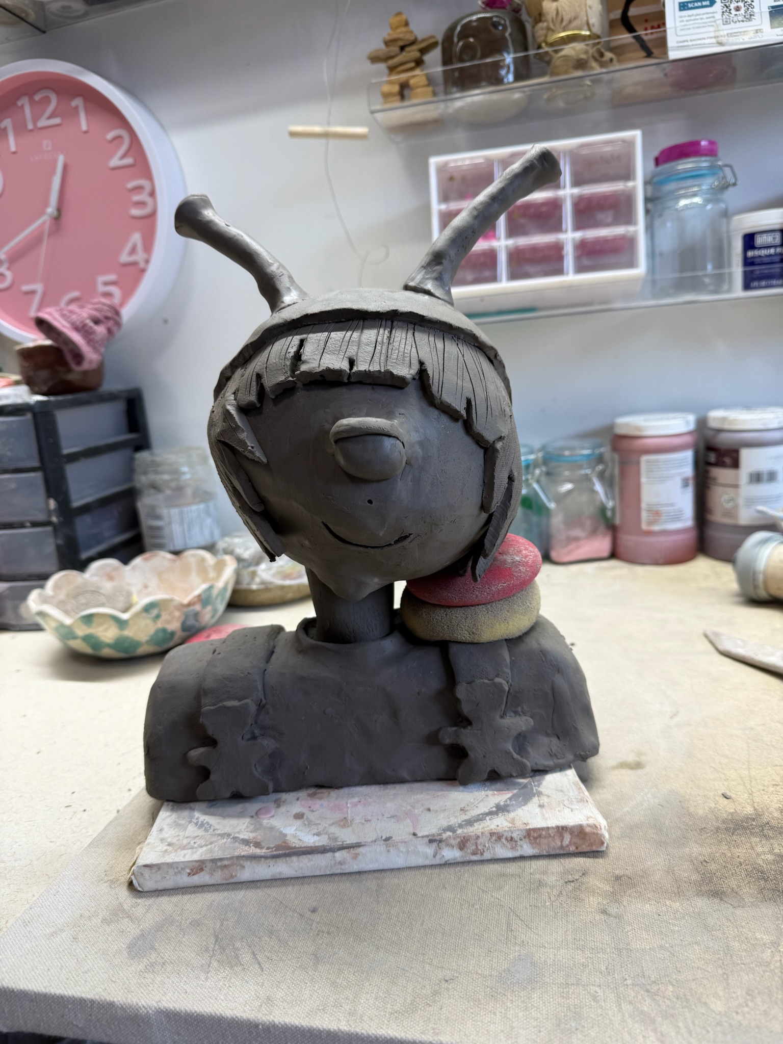 Raw clay bust with flowers
